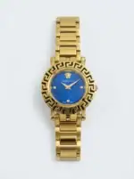 Gold Versace watch with blue dial and Greek key bezel design.