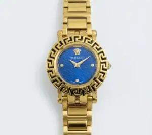 Gold Versace watch with blue dial and Greek key bezel design.