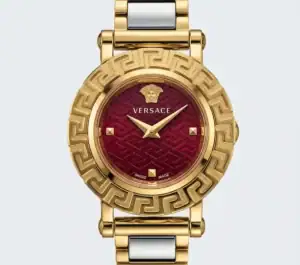 Luxury watch with red dial and gold-tone case and bracelet.