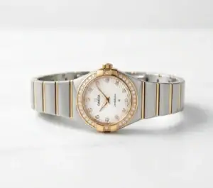 Luxury women's watch with two-tone gold and silver finish and diamond accents.