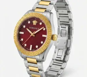 Luxury Versace watch with red dial, gold and silver band, Greek key bezel.