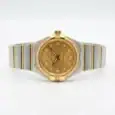 Luxury gold and silver women's watch with diamond accents and monogram dial.