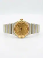 Luxury gold and silver women's watch with diamond accents and monogram dial.