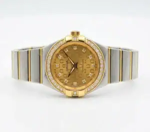 Luxury gold and silver women's watch with diamond accents and monogram dial.