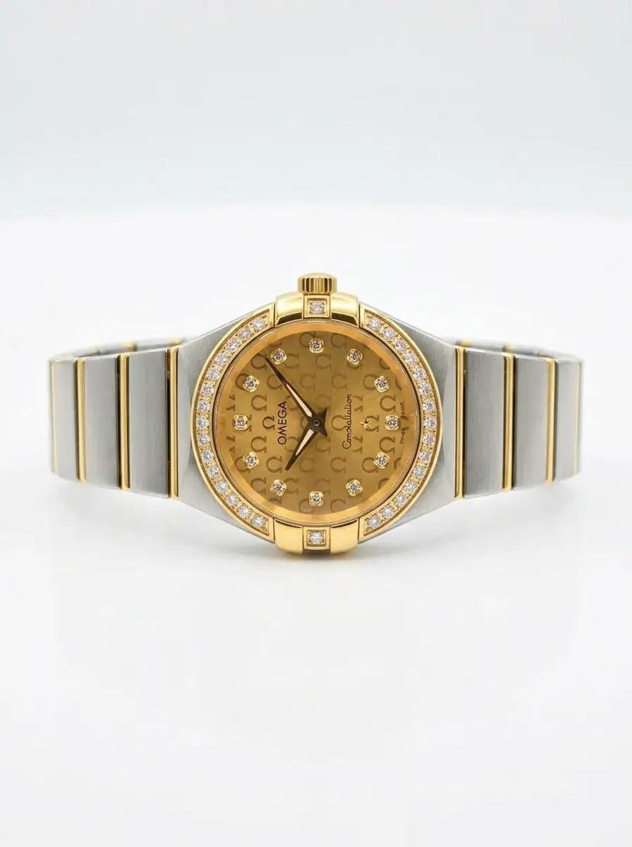 Omega Constellation Gold Monogram Women Watch Luxury gold and silver women's watch with diamond accents and monogram dial.