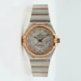 Luxury Omega Constellation watch with diamond-studded bezel and feather-patterned dial.