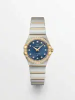 Luxury Omega Constellation watch with blue dial, diamond accents, and two-tone bracelet.