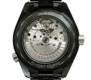 Close-up of Omega Planet Ocean watch with visible movement and black strap.
