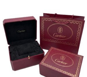 Elegant Cartier jewelry box set in deep red with gold accents and interior padding.