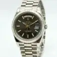Rolex Day-Date silver stainless steel watch with black dial and date display.