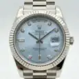Rolex Day-Date watch with ice blue dial and diamond hour markers.
