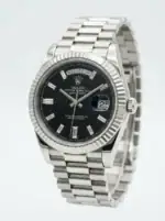 Rolex Day-Date watch with black dial, baguette hour markers, and stainless steel bracelet.
