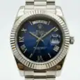 Rolex Day-Date watch with blue dial, Roman numerals, and stainless steel bracelet.