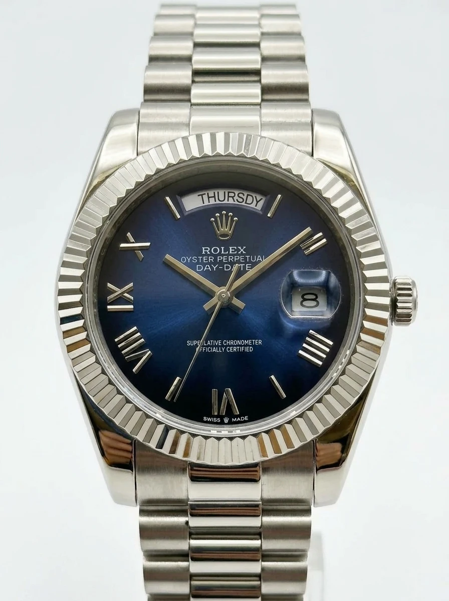Rolex Day-Date Blue Roman Steel Watch Rolex Day-Date watch with blue dial, Roman numerals, and stainless steel bracelet.
