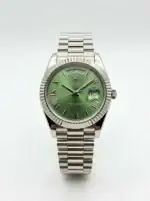 Rolex Day-Date watch with green dial, Roman numerals, and stainless steel band.