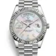 Rolex Day-Date watch with mother-of-pearl dial and diamond hour markers.