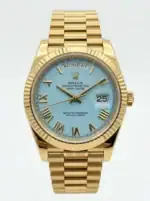 Rolex Day-Date watch with turquoise dial and gold bracelet, day and date display.