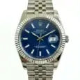 Rolex Datejust with blue dial and silver bracelet, fluted bezel, date window at 3 o'clock.