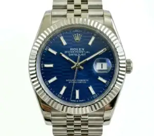 Rolex Datejust with blue dial and silver bracelet, fluted bezel, date window at 3 o'clock.