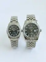Silver Rolex Datejust couple watches with black dials and diamond markers.