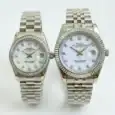 Pair of Rolex Datejust watches with silver bands and white dials, one with diamond hour markers.