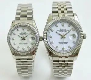 Pair of Rolex Datejust watches with silver bands and white dials, one with diamond hour markers.