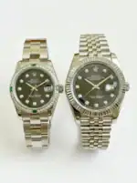 Pair of Rolex Datejust watches with silver bands and black dials, one with diamond hour markers.