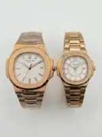 Pair of rose gold Patek Philippe Nautilus watches with white dials and bracelet straps.